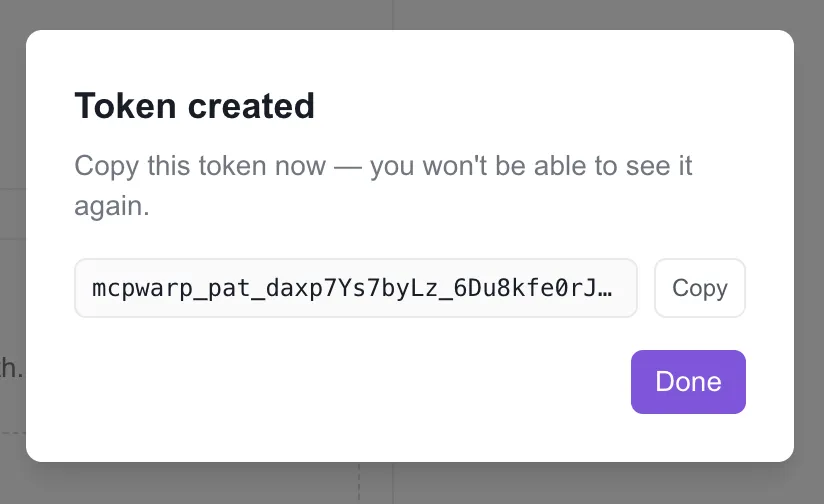 The dashboard’s Token created dialog showing a new mcpwarp_pat_ token with a Copy button and a warning that it won’t be shown again.